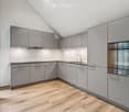 kitchen with wooden floors, gray cabinets, oven, sink, faucet, modern design