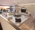 Modern living room with a view, featuring a sectional sofa, coffee table, fireplace, TV, dining area, and large windows overlooking the water.