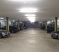 {"visible_features": ["Garage", "Parking place"], "type": "Garage", "objects": [], "description": "Underground parking garage with multiple parked cars, yellow painted parking lines, and overhead lighting.", "localized_descriptions": {"EN": "Underground p