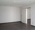 empty room, white walls, wooden floor, two doors