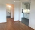 empty room with wooden floors, white walls, sink, oven