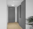 Modern hallway with light wooden flooring, white walls, grey cabinetry, and a single recessed ceiling light.