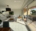 Bright living room with large sliding glass doors opening to a balcony, white sofa, coffee table, floor lamp, and artwork on the walls.