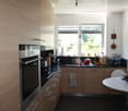 {"visible_features": ["View"], "type": "Kitchen", "objects": ["oven", "sink", "faucet", "cupboard", "table", "chair", "bowl", "faucet", "faucet", "faucet", "faucet", "faucet", "faucet", "faucet", "faucet", "faucet", "faucet", "faucet", "faucet", "faucet",