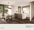 Modern kitchen with a central island, dining area, pendant light, and sleek cabinetry.