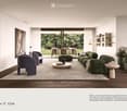 Modern living room with a large green sectional sofa, a round coffee table, armchairs, ottoman, floor lamp, dining area with chairs and table, shelves, plants, and artwork.