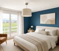 Modern bedroom with a large bed, nightstand, armchair, pendant light, and a view of a green field through large windows.