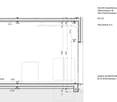 Floor plan of a commercial space with labeled dimensions, showing a rectangular room with a raised section and access points.