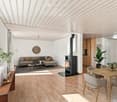 Modern living and dining area with light wood flooring, a grey sectional sofa, a black wood-burning stove, a wooden dining table with chairs, and decorative plants.
