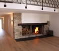 Fireplace made of stone, wood floors, modern design