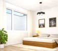 Modern bedroom with a wooden bed, nightstand, table lamp, potted plant, and two framed pictures on the wall.