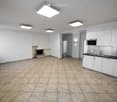Empty kitchen and living area with white cabinets, stainless steel appliances, tiled floor, and a fireplace.
