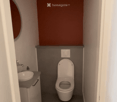 Modern compact bathroom with a toilet, sink, and faucet, featuring a dark grey wall and a brown accent wall.