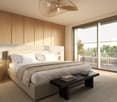 Modern bedroom with a large bed, nightstands, a bench at the foot of the bed, and a balcony with outdoor furniture visible through large windows.