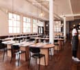 restaurant, wooden floor, tables, chairs, pendant lights, wine bottles