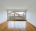 empty room, wooden floor, white walls, large glass doors leading to balcony, white ceiling