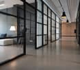 modern office space, glass walls, concrete floor, white walls, modern furniture, lamps
