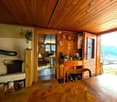 Rustic wooden interior with a fireplace, wooden furniture, and decorative items on the walls