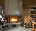 wooden walls, fireplace, floor heater, shelving, fire extinguisher