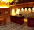 wooden walls, wood floor, fireplace, desk, bookshelf, windows