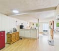kitchen with kitchen island, gas stove, double doors, microwave, and windows