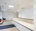 tiled floor, white walls, reception desk, cabinets, fire extinguisher, sink