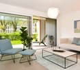 modern room, light walls, large window, balcony, plants, comfortable couch, table, lamp