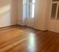 empty room, wooden floor, white walls, windows, power outlets