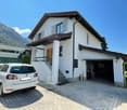 2 story house, white exterior, brown roof, garage, mountain view