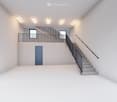Wide room with a staircase leading to upper floor