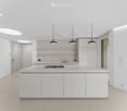 modern kitchen with island, white cabinets, white countertops, modern lighting, no appliances visible