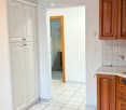 modern kitchen, marble countertop, white cabinets, power outlets, tiled floor