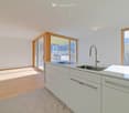 White cabinetry, wooden floor, glass doors, stainless steel faucet, kitchen counter, sink, range hood, built-in oven, panoramic view of the outside