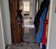 Marble floor, wooden cabinet, mirror, clothes hanging on the wall