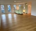 empty room, wooden floor, white walls, glass doors, kitchen with sink and cabinets, balcony