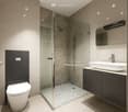 modern bathroom with glass shower, white toilet, white sink, mirror, tiled floor