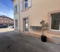 2 story house, beige exterior, white windows, mailboxes, potted plant, parking lot