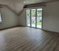 Unfurnished Room. Empty room with wooden floors, white walls, and large windows leading to a balcony.