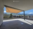 Balcony / Terrace. Balcony with tiled floor, metal railing, retractable awning, and scenic mountain view.