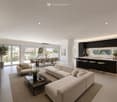 Open-concept living and dining area with a modern sofa, coffee table, dining table, and kitchen island. Large windows offer a view of the outdoor space.