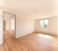 empty room, hardwood floors, white walls, natural light from window
