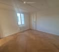 empty room, wooden parquet floor, white walls, window, radiator, door