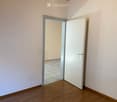 empty room, white walls, wooden floor, open door, tiled floor in the next room