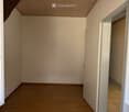 empty room, wooden floor, white walls, two windows, open door