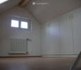white walls, wooden ceiling, white shelves, radiator, floor
