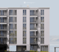 Modern multi-story residential building with large windows and balconies, featuring a clean, contemporary design.
