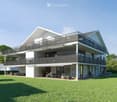 Modern two-story house with white exterior, large windows, and balconies. The house features a spacious lawn and patio area with outdoor furniture.