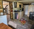 {"type": "Furnished Room", "objects": ["wooden table", "sofa", "wooden cabinets", "sink", "faucet", "oven", "fridge", "oven", "fridge", "fridge", "oven", "oven", "oven", "oven", "oven", "oven", "oven", "oven", "oven", "oven", "oven", "oven", "oven", "oven