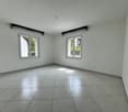 Empty room with white walls, tiled floor, two windows, and a door.