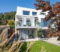 modern white house, 2 stories, large windows, balcony, garage, garden